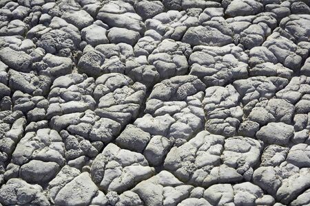 Dry soil with deep cracks. Cracked mud surface. Texture of cracks on the ground.の写真素材