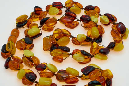 Necklace made of natural multi-colored amber. Solid translucent fossilized resin from extinct tertiary conifers. Decoration, beads for women.の写真素材