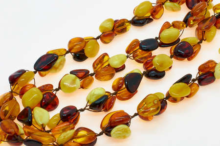 Necklace made of natural multi-colored amber. Solid translucent fossilized resin from extinct tertiary conifers. Decoration, beads for women.の写真素材