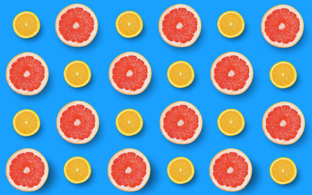 Slice of grapefruit and orange fruit on blue background. Citrus pattern background