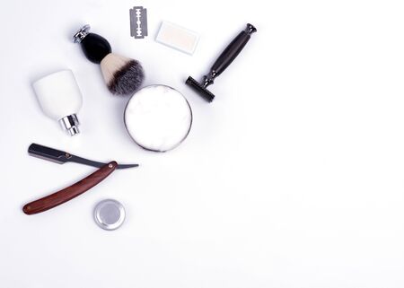 Razor, brush, blade, balsam, shaving foam and perfume on a white background.の写真素材