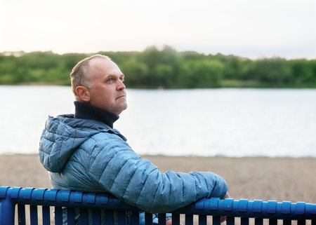 Man sitting on a bench near the  lake