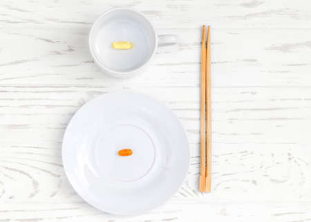 white plate and cup with food additives and chopsticksの写真素材