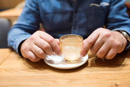 man holding an empty glass after the coffee breakの写真素材