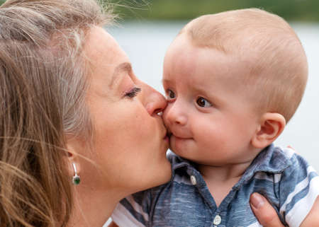 mother holding and kissing sonの写真素材