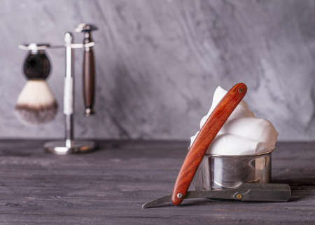 Razor, brush, and foam on a wooden grey backgroundの写真素材