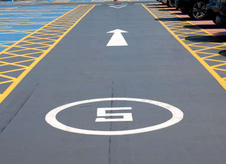 Markings and signs on the road in the Parking lotの写真素材