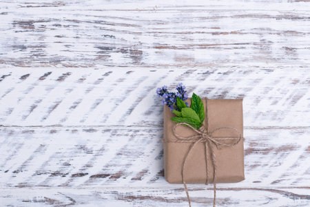 gift and posy of lavender on wooden background
