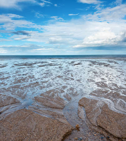 Sand beach, sea and cloudy blue sky in England in dayの写真素材