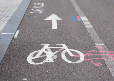 bicycle lane sign in a city and other road signsの写真素材