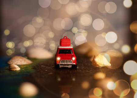 Toy car on the seaside between seashells on the background of bokeh