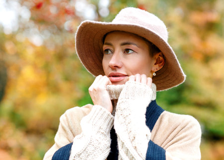 Portrait of  woman in hat in autumn park