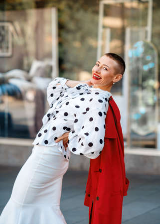 portrait of a fashion woman in white skirt and blouse  walking around the cityの写真素材