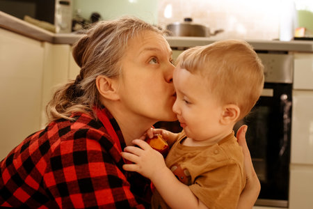 mother and son in kitchen at home