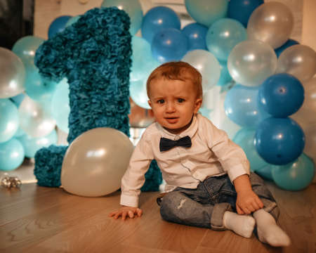 baby child with balloons having his birthdayの写真素材