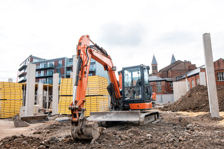 an orange excavator  placed on the ground in safe  position