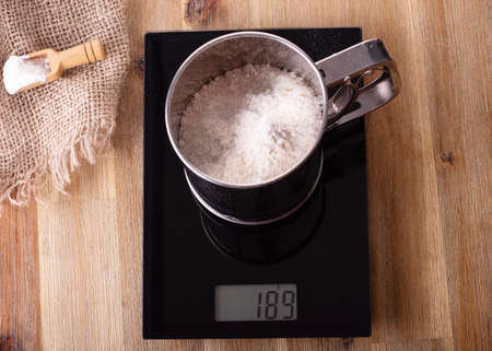 Flour Sifter Sieve Stainless with flour on the scaleの写真素材