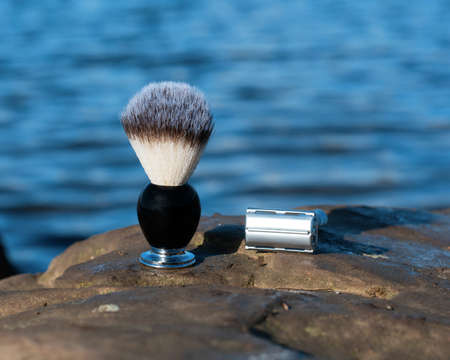 razor and brush on a wooden pier on the seaside in the morningの写真素材