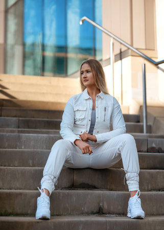 young woman in white costume walking around cityの写真素材