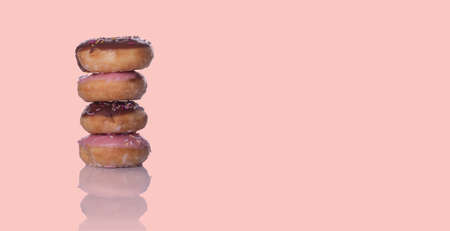 banner of  four doughnuts on pink backgroundの写真素材