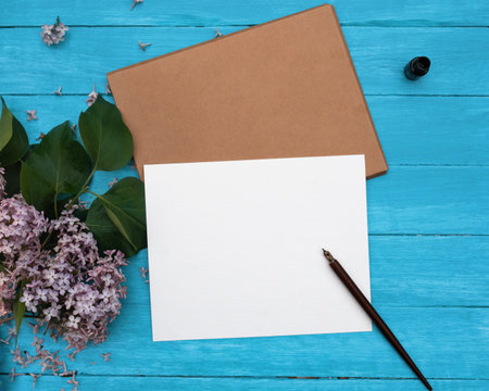 One Craft envelop, white paper, brunch of lilac, heatrs, candle on vintage turquoise wooden...
