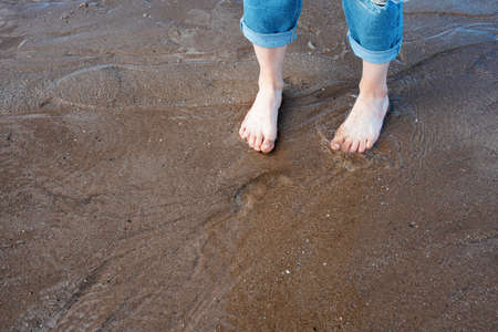 feet on the beach in sunny summer dayの写真素材