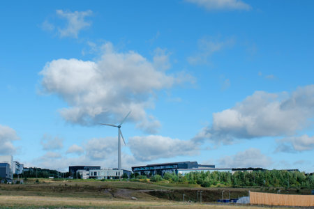 An electricity generating windmills in the countryside against blue cloudy skyの写真素材