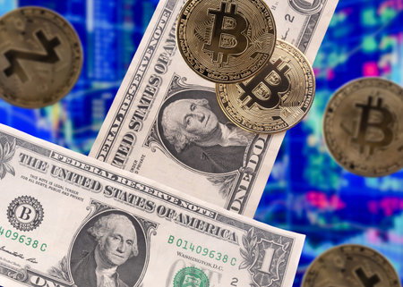 bitcoins and dollars on blur charts background