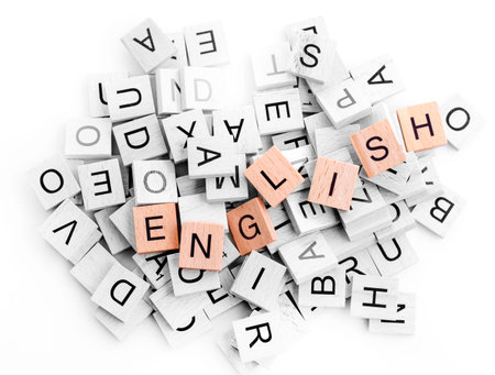 black and white wooden alphabet blocks and wooden word English on white background