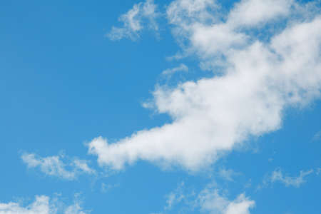 white cirrus, feathery clouds against spring bright blue cloudy sky on sunny day in Englandの写真素材