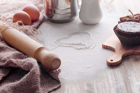 baking ingredients egg, flour, oil and muffin for baking on a wooden backgroundの写真素材