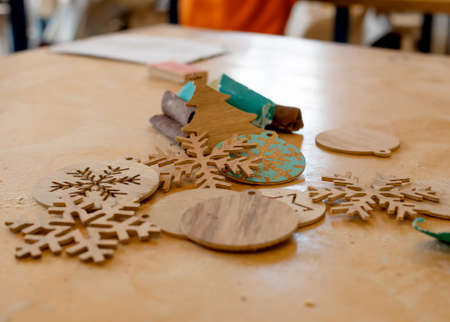 Handmade wooden Christmas decoration, resting on a desk in a woodworking shopの写真素材