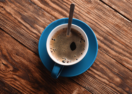 blue  cup of coffee  on the wooden background
