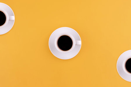 cup of americano coffee on a yellow background. Space for text.の写真素材
