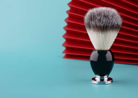 Close up of brush for shaving on a red and meant  backgroundの写真素材