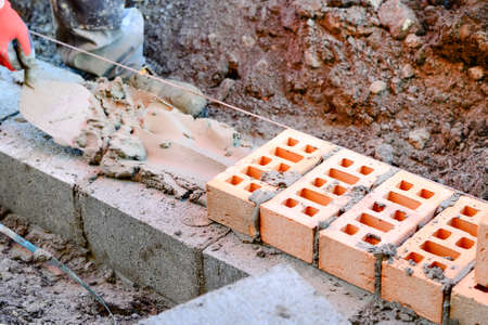 Bricklayer  laying brick on building siteの写真素材