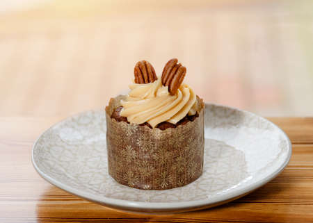chocolate cake with almond on th top on a table in cafeの写真素材