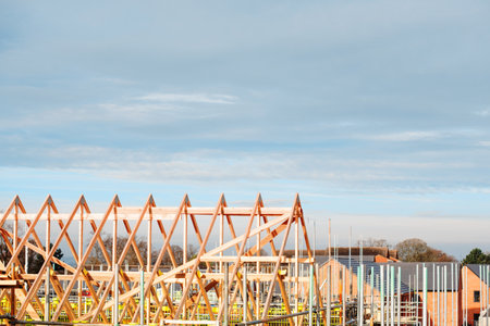 Roof erection is in progress. Trusses installed on top of new houseの写真素材