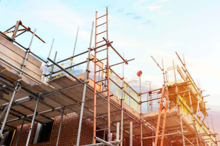 Scaffolding erected around houses in a new housing developmentの写真素材