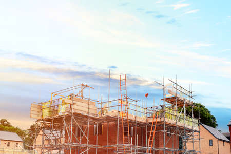 Scaffolding erected around houses in a new housing developmentの写真素材