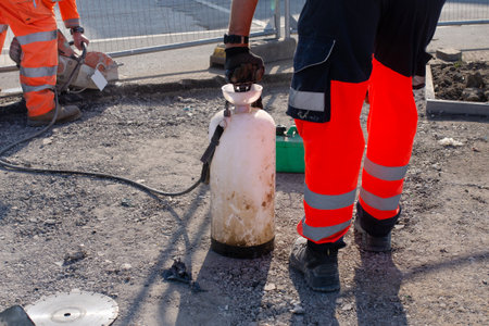 Groundworker cutting asphalt with petrol sawの写真素材