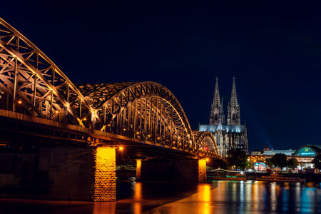 GERMANY, COLOGNE- JUNE, 24, 2022: THE RHINE EMBANKMENT AT NIGHT  the Cologne Cathedral Dom and the Hohenzollern Bridgeのeditorial素材