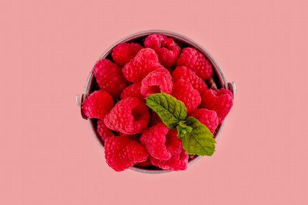 fresh raspberry in a cup on pink background