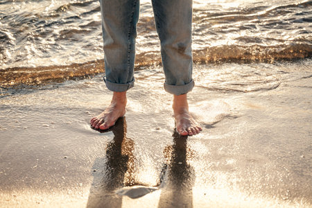 Close up of woman feet walking barefoot on seaside . Vacation, travel and freedom concept. People relaxing in summer.の写真素材