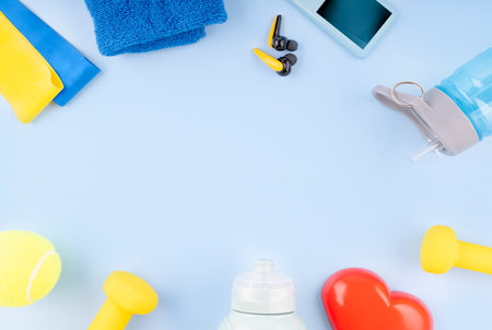 Neoprene Dumbbells, Fitness Bands Elastic, bottle, towel on blue background Top view, flat lay Fitness and healthy living, wellness concept.の写真素材