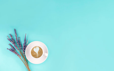 white small cup of coffee and lavander on a blue background. Space for textの写真素材