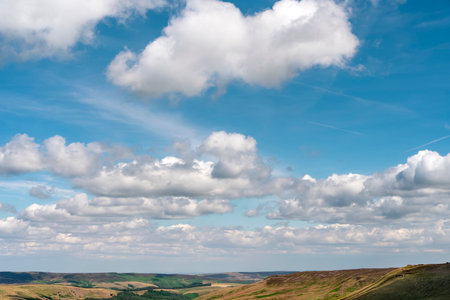 white cirrus, feathery clouds against spring bright blue cloudy sky on sunny day in Englandの写真素材