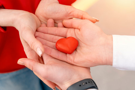 Couple holding red heart. Getting together in love conceptの写真素材
