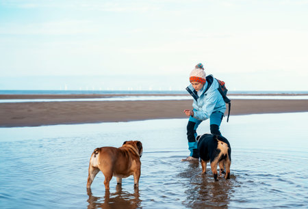 Happy woman tourist with her dogs hiking and exploring new placesの写真素材
