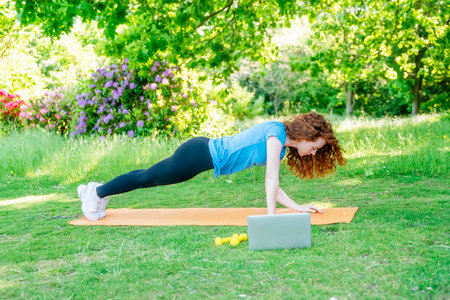 The happy person doing yoga and exercise in nature for mental health, wellness, and fitnessの写真素材